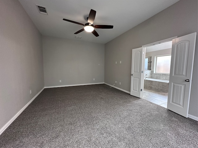 unfurnished bedroom featuring ensuite bathroom, ceiling fan, and carpet flooring