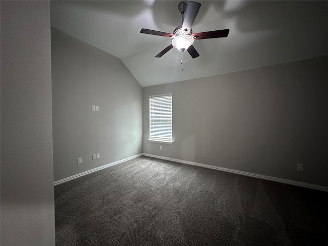 carpeted spare room featuring lofted ceiling and ceiling fan