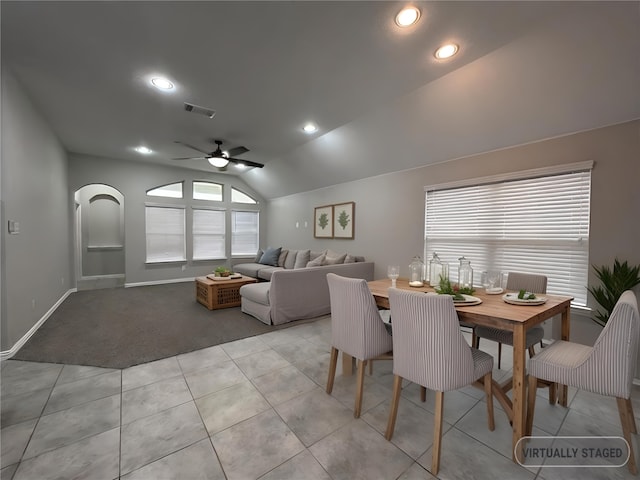 dining room featuring light tile patterned flooring, lofted ceiling, and ceiling fan