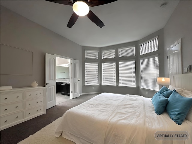 bedroom with connected bathroom, ceiling fan, multiple windows, and dark carpet