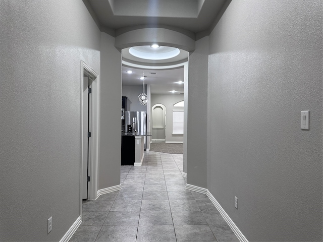 hall with light tile patterned floors