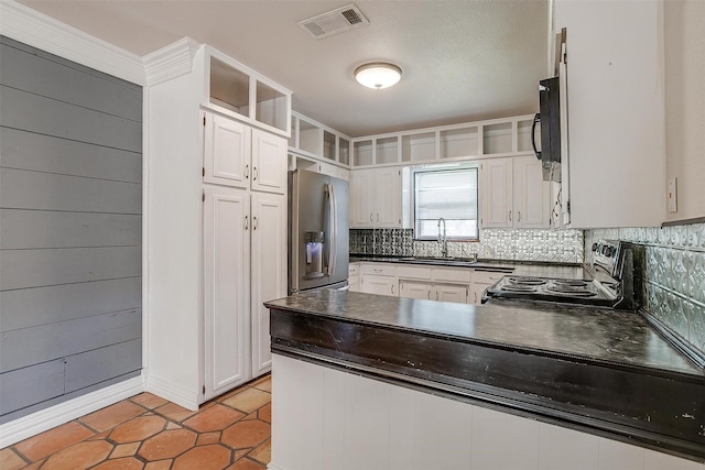 kitchen with sink, stainless steel fridge with ice dispenser, electric range, white cabinets, and backsplash