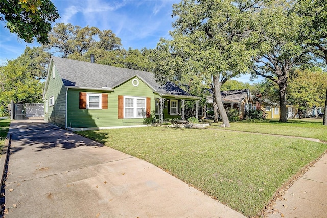 2309 Honeysuckle Ave, Fort Worth, TX 76111 - view of front of house with concrete driveway, a front yard, roof with shingles, and a gate