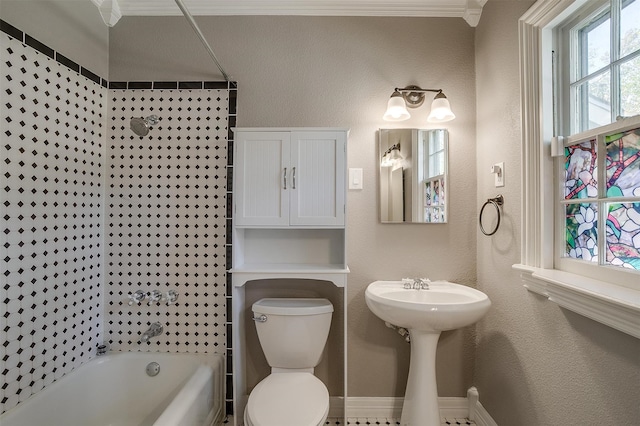 full bathroom with crown molding, sink, tiled shower / bath combo, and toilet