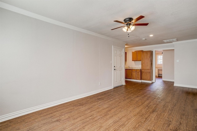 unfurnished living room with dark hardwood / wood-style flooring, crown molding, a textured ceiling, and ceiling fan