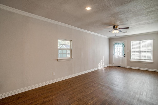 unfurnished room with ornamental molding, dark hardwood / wood-style floors, a textured ceiling, and ceiling fan