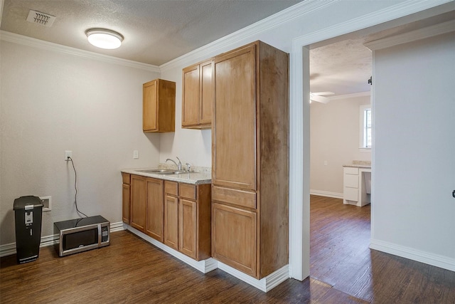 2309 Honeysuckle Ave, Fort Worth, TX 76111 - kitchen with stainless steel microwave, a sink, dark wood finished floors, ornamental molding, and baseboards
