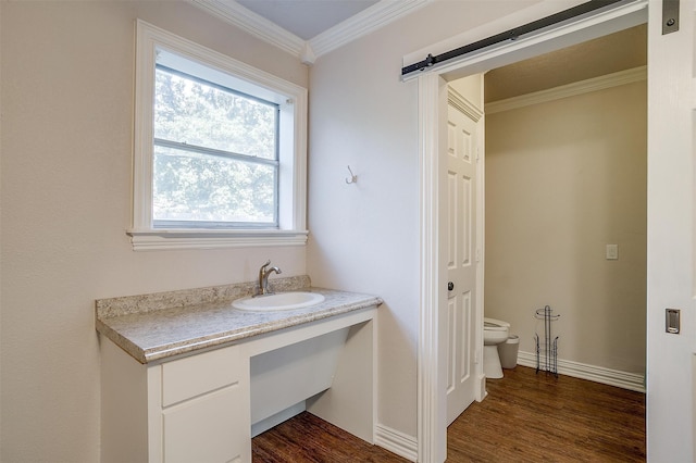 bathroom with crown molding, vanity, toilet, and hardwood / wood-style flooring