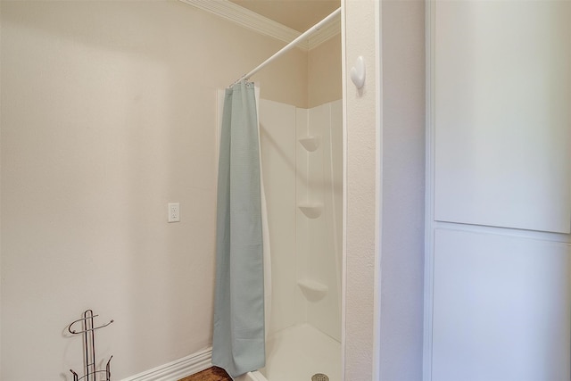 bathroom featuring a shower with curtain and ornamental molding