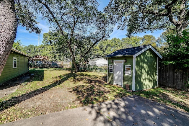 2309 Honeysuckle Ave, Fort Worth, TX 76111 - fenced backyard with a storage unit and an outbuilding
