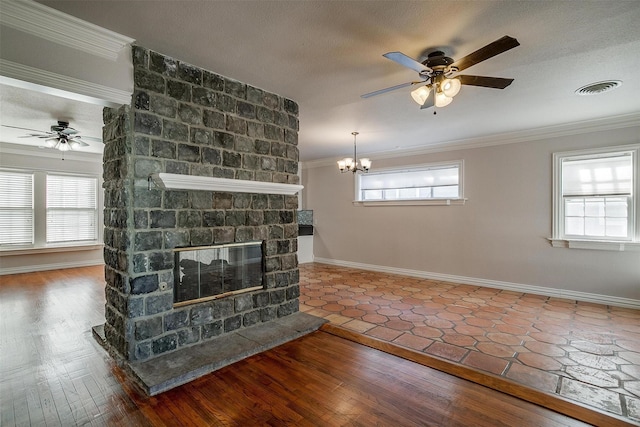 living room with crown molding, a textured ceiling, hardwood / wood-style floors, a fireplace, and ceiling fan with notable chandelier