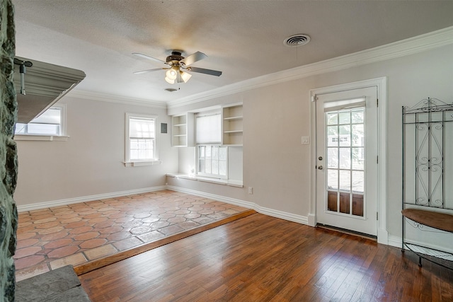 interior space with built in shelves, crown molding, wood-type flooring, a textured ceiling, and ceiling fan