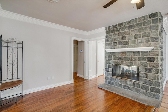 living room with hardwood / wood-style floors, crown molding, ceiling fan, and a multi sided fireplace