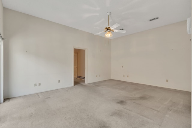 spare room featuring visible vents, light colored carpet, and a ceiling fan