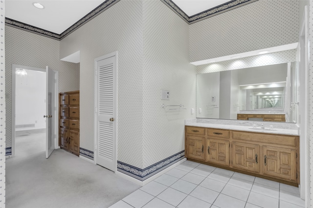 bathroom with tile patterned floors, a walk in shower, wallpapered walls, and vanity