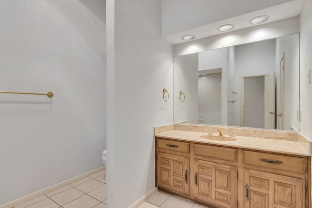 bathroom with vanity, tile patterned floors, toilet, and baseboards