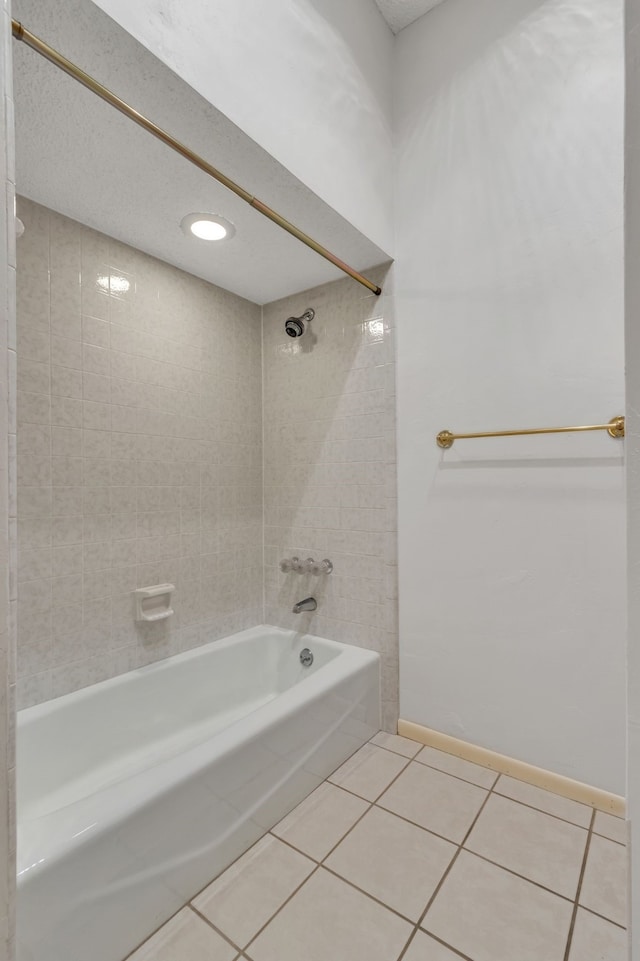 bathroom with tile patterned flooring, washtub / shower combination, and baseboards