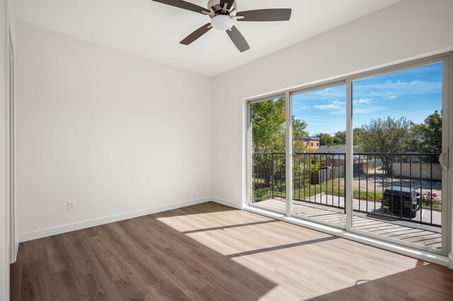 spare room with hardwood / wood-style floors and ceiling fan