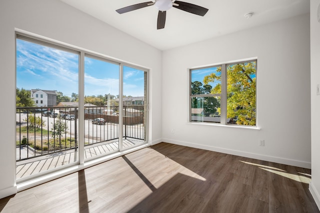 spare room featuring dark hardwood / wood-style flooring and ceiling fan