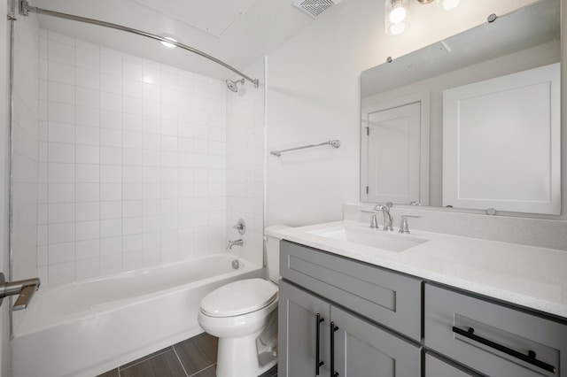 full bathroom with toilet, tiled shower / bath combo, and vanity