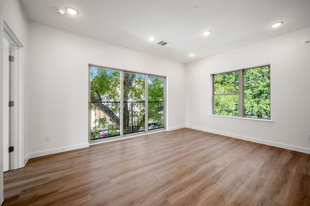 unfurnished room with hardwood / wood-style floors