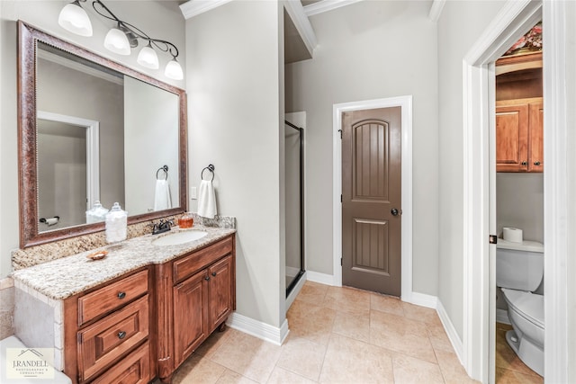 bathroom featuring tile patterned floors, ornamental molding, vanity, an enclosed shower, and toilet