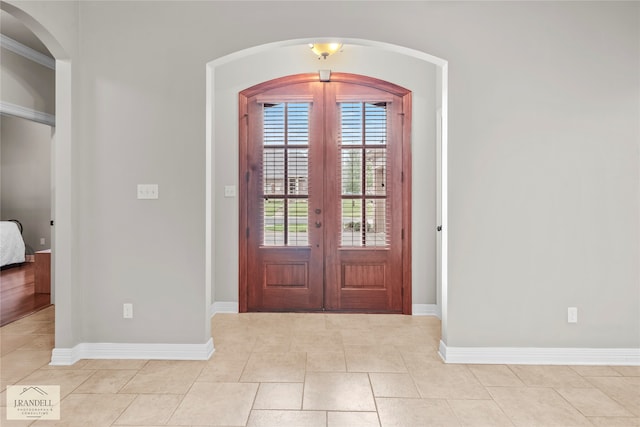 foyer with french doors and light tile patterned flooring