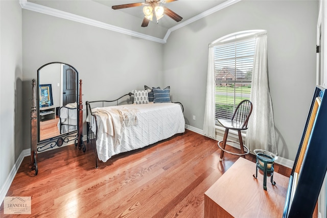 bedroom featuring ornamental molding, wood-type flooring, and ceiling fan