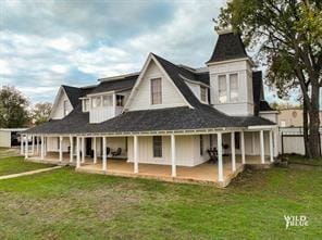 back of property featuring a patio area and a lawn