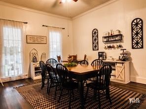 dining room with ornamental molding, ceiling fan, and dark hardwood / wood-style floors