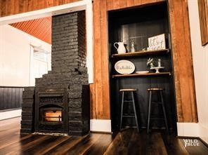 bar featuring wood walls and dark hardwood / wood-style floors