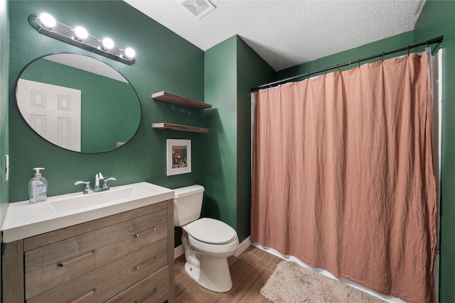 bathroom with wood-type flooring, a textured ceiling, toilet, vanity, and a shower with shower curtain