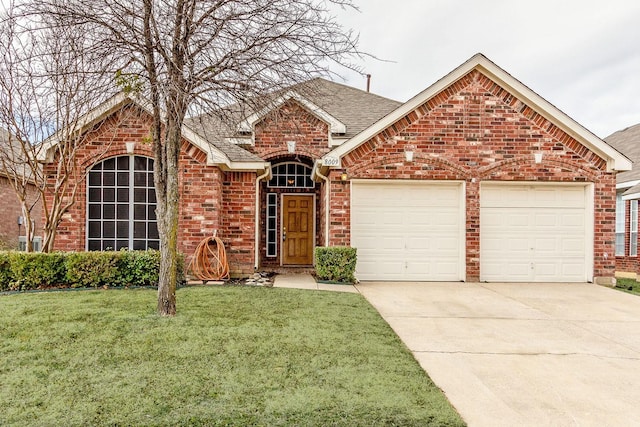 ranch-style house featuring an attached garage, brick siding, a shingled roof, driveway, and a front yard