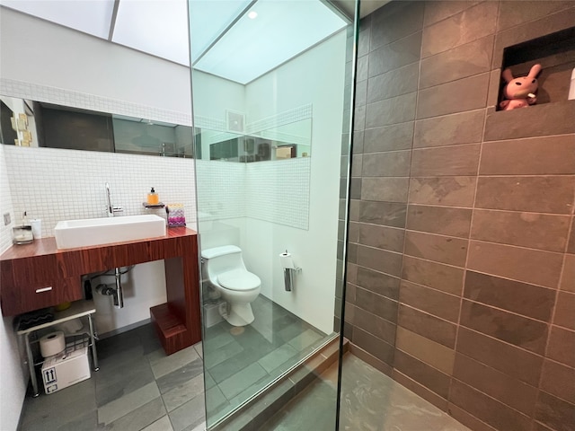 bathroom with tile walls, tile patterned floors, walk in shower, backsplash, and sink