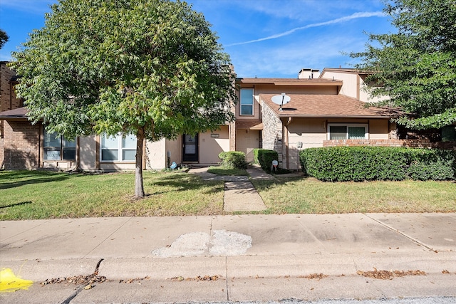 view of front of house with a front yard and a garage