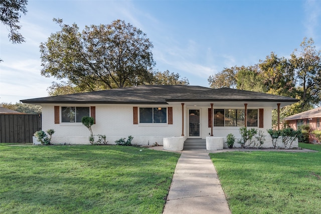 ranch-style home featuring a front yard