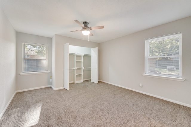 unfurnished bedroom with ceiling fan and light colored carpet