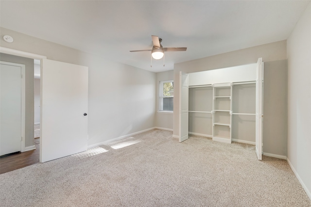 unfurnished bedroom with ceiling fan, light colored carpet, and a closet