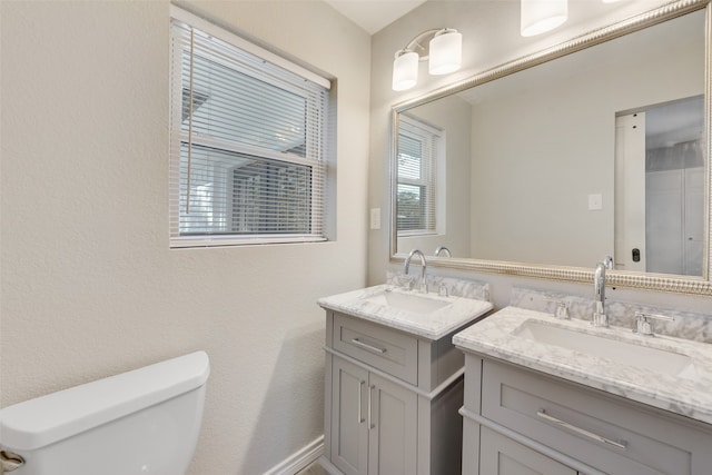 bathroom featuring toilet and vanity