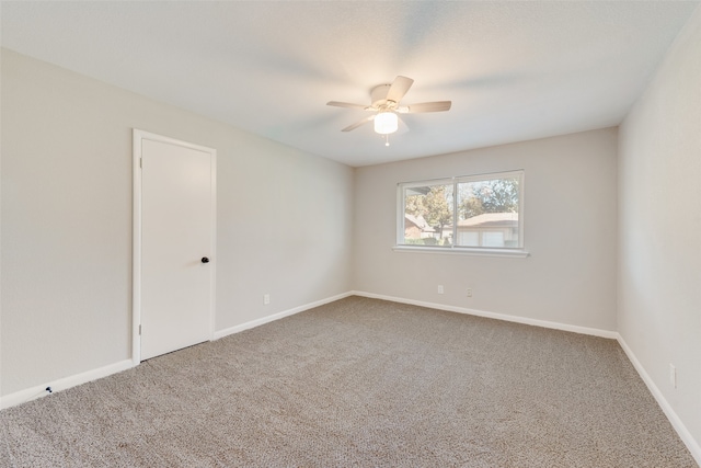 empty room featuring ceiling fan and carpet floors