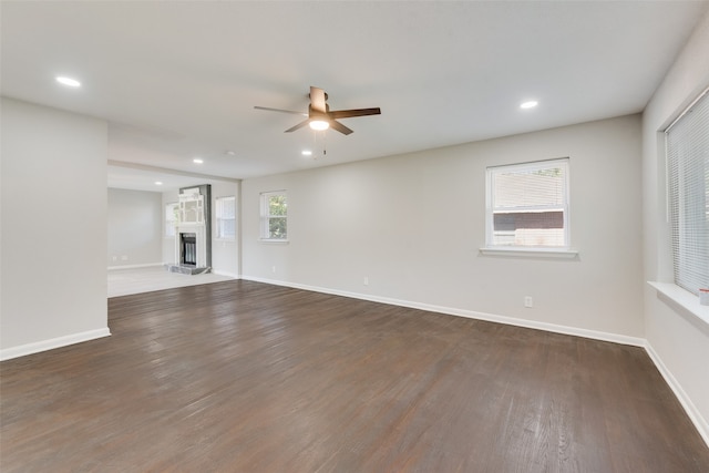 empty room with ceiling fan and dark hardwood / wood-style floors