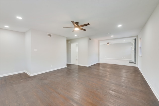 empty room featuring ceiling fan and dark hardwood / wood-style flooring