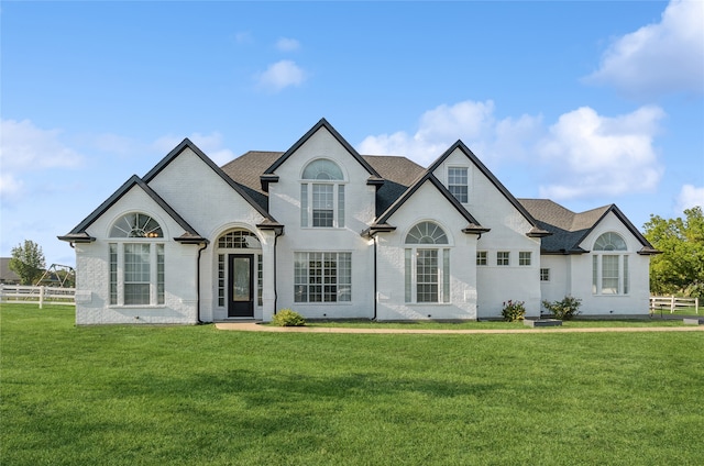 french country home featuring a front lawn