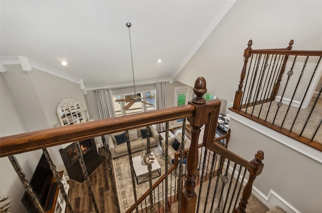 stairs featuring ceiling fan and ornamental molding