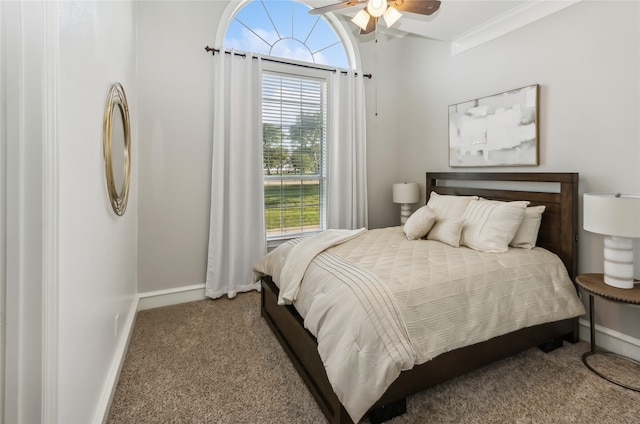 bedroom featuring ceiling fan, multiple windows, crown molding, and carpet