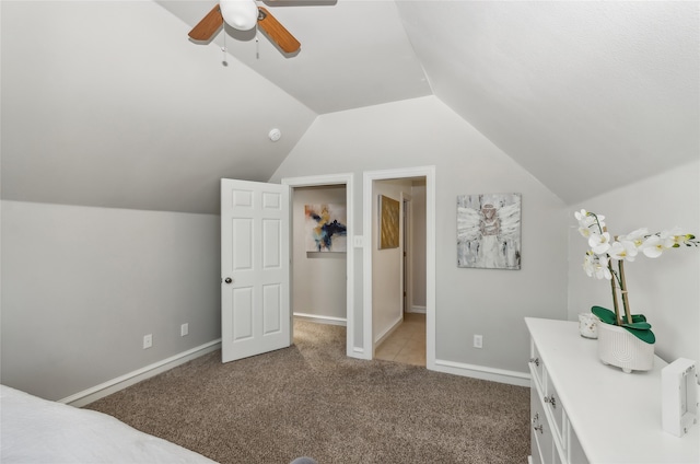 bedroom featuring light carpet, ceiling fan, and vaulted ceiling