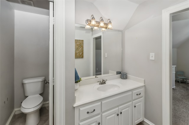 bathroom featuring lofted ceiling, toilet, and vanity