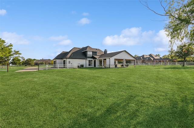 rear view of property featuring a yard