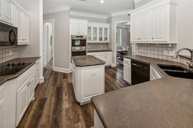 kitchen featuring white cabinets, decorative backsplash, black appliances, and sink