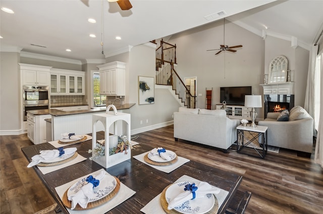 living room with dark hardwood / wood-style flooring and crown molding